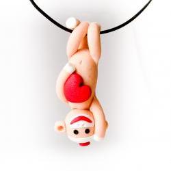 Orange Sock Monkey Pendant Swinging Upside Down holding a Valentine's Day Heart